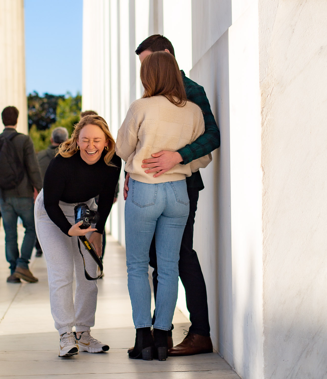 Photographer laughing hard at a photo shoot on the Lincoln Memorial
