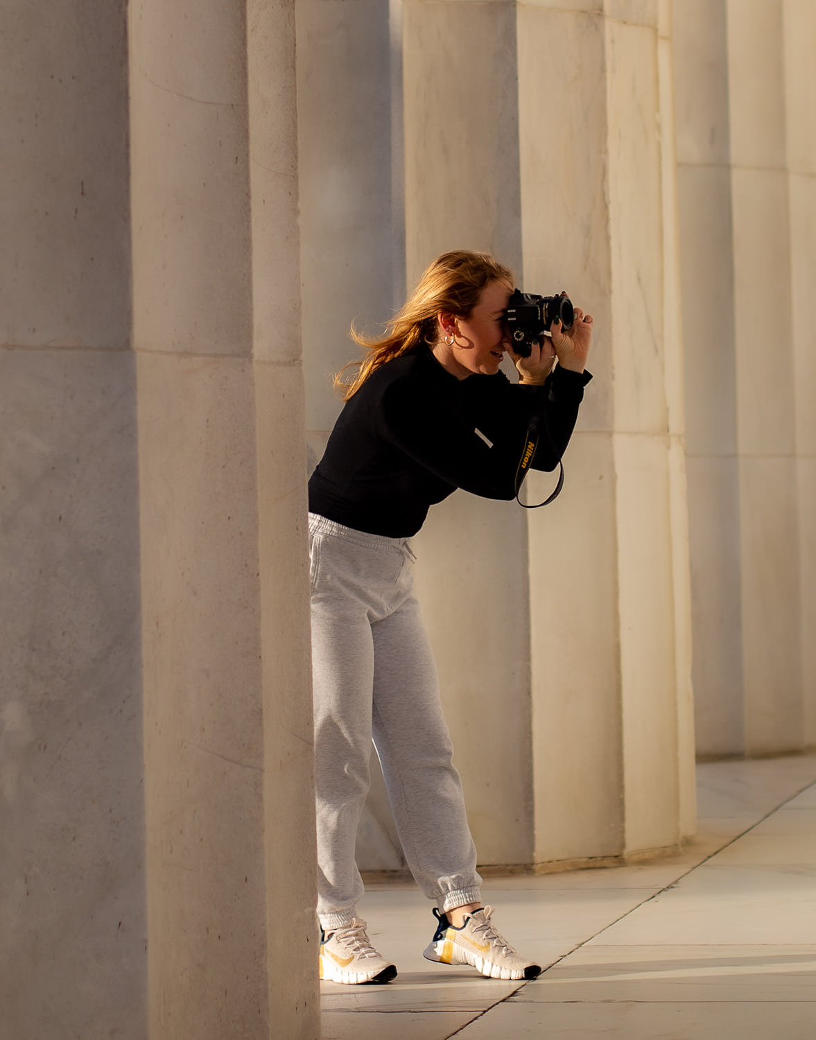 Photographer doing a shoot on the Lincoln Memorial during golden hour