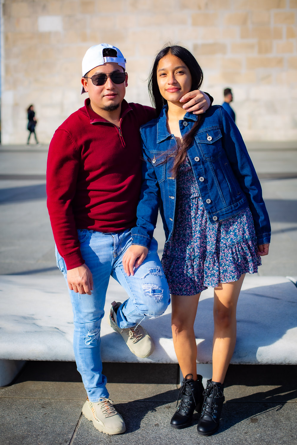 Couple on the street posing in front of the Washington Monument
